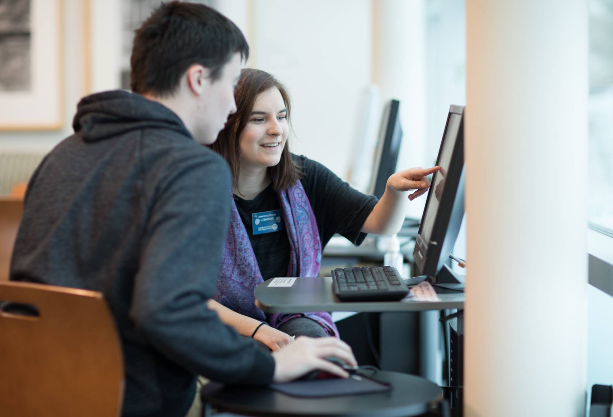 Student and instructor looking at computer